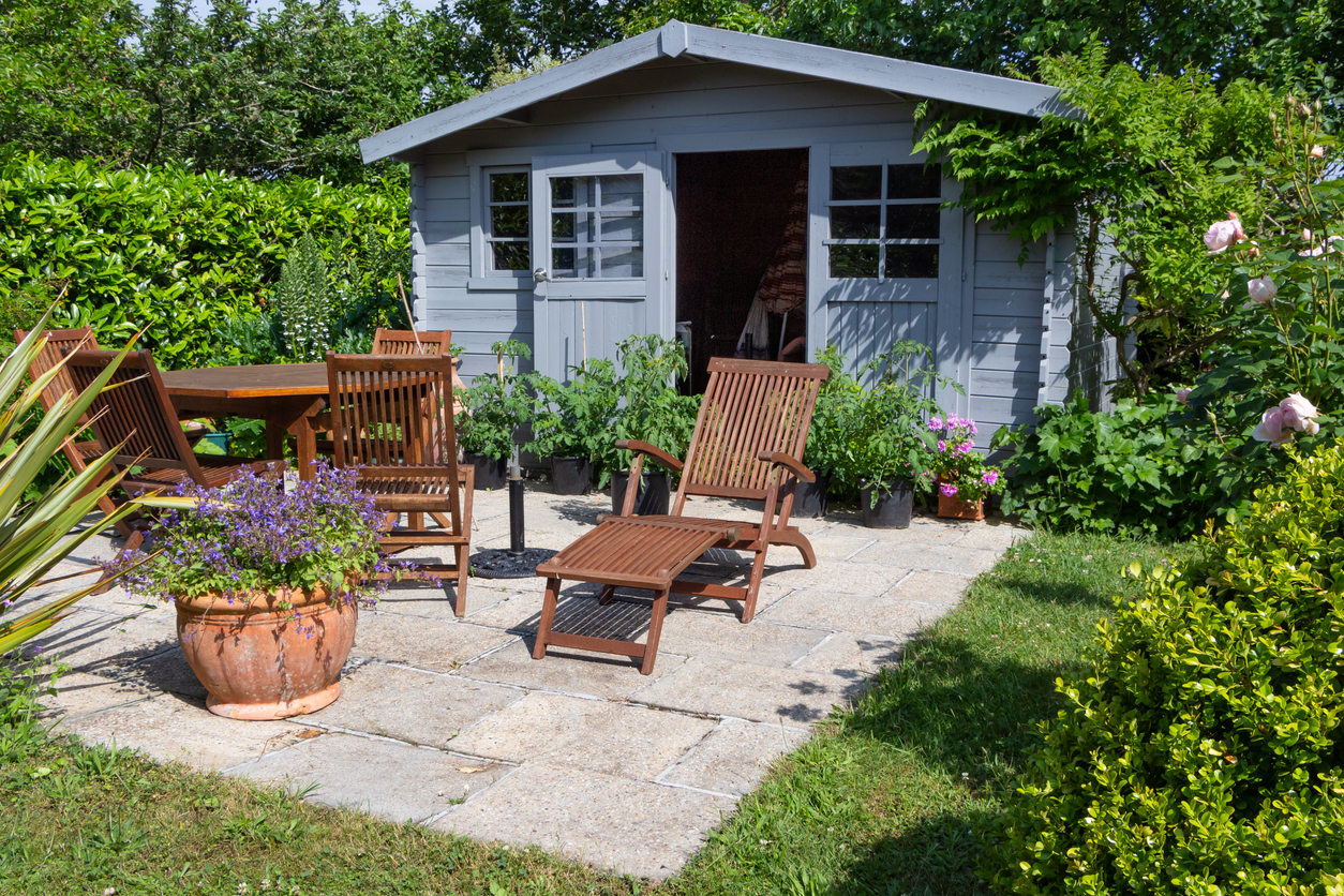custom garden shed with patio in backyard