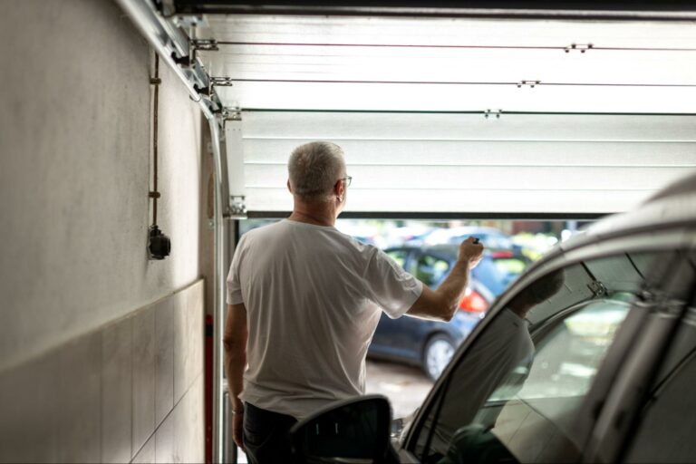 man-closing-garage-with-vehicle-inside